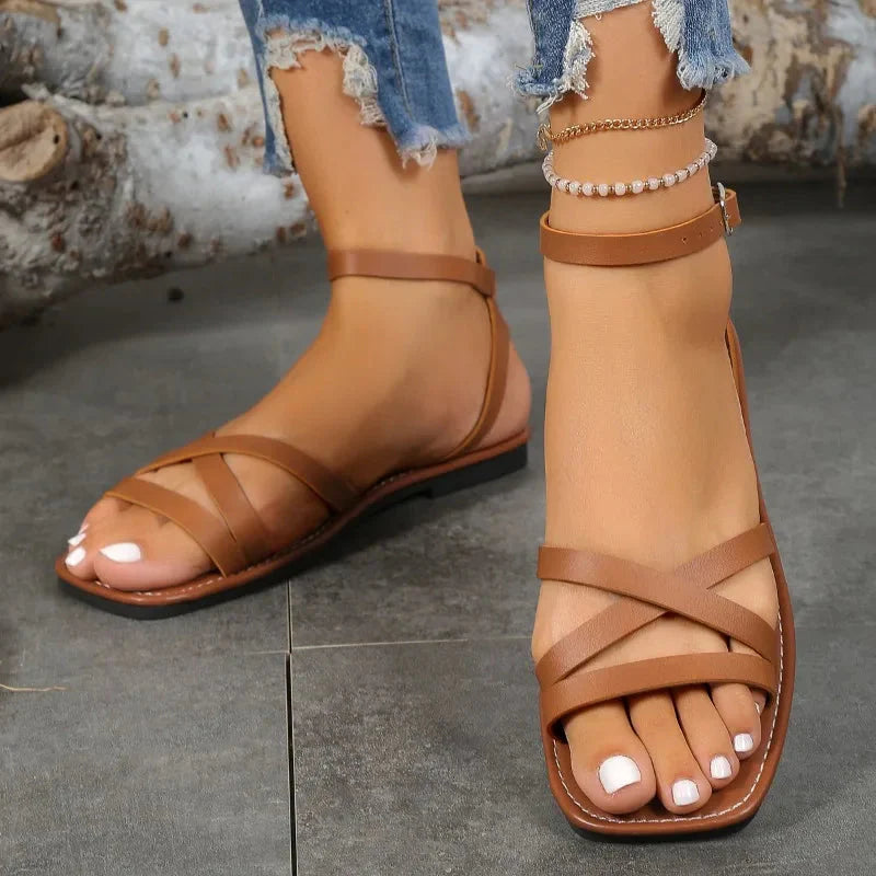 Brązowe sandały z paskami krzyżowymi i paskiem wokół kostki